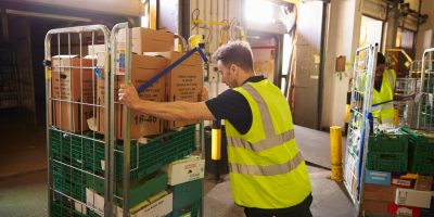 Man,Pushing,A,Roll,Cage,Ready,For,Delivery,In,A Man,Pushing,A,Roll,Cage,Ready,For,Delivery,In,A
